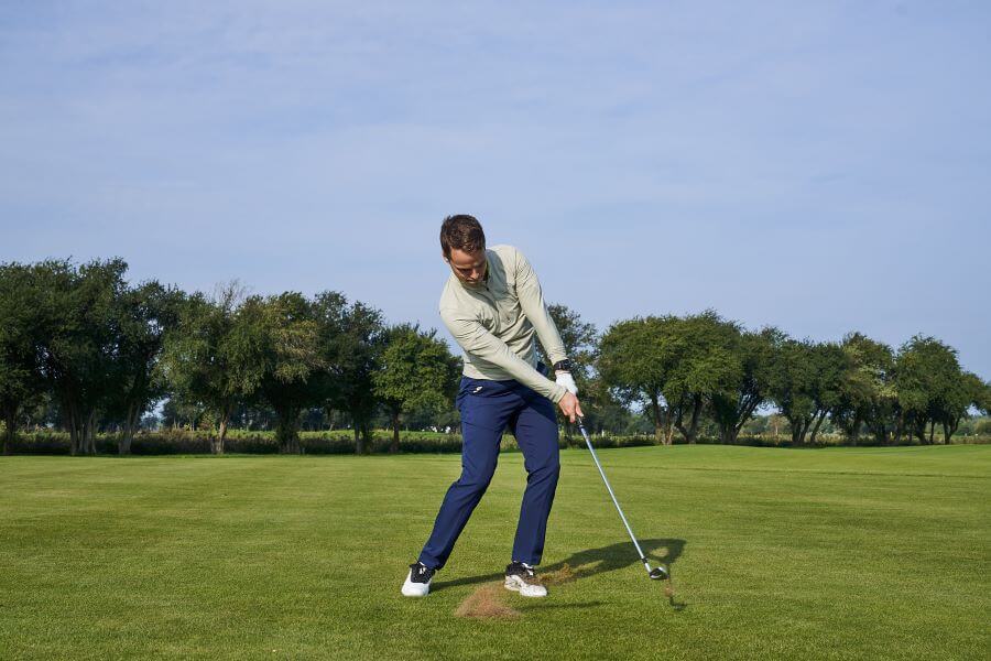 golfer on golf course release the golf club