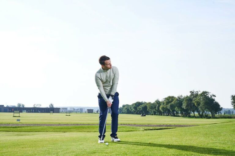 golfer pitching on golf course