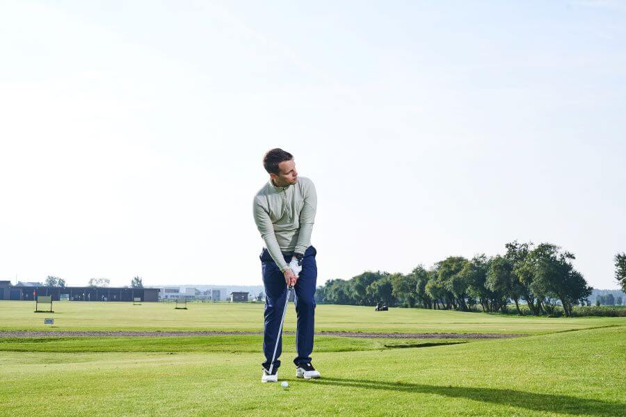 golfer pitching on golf course