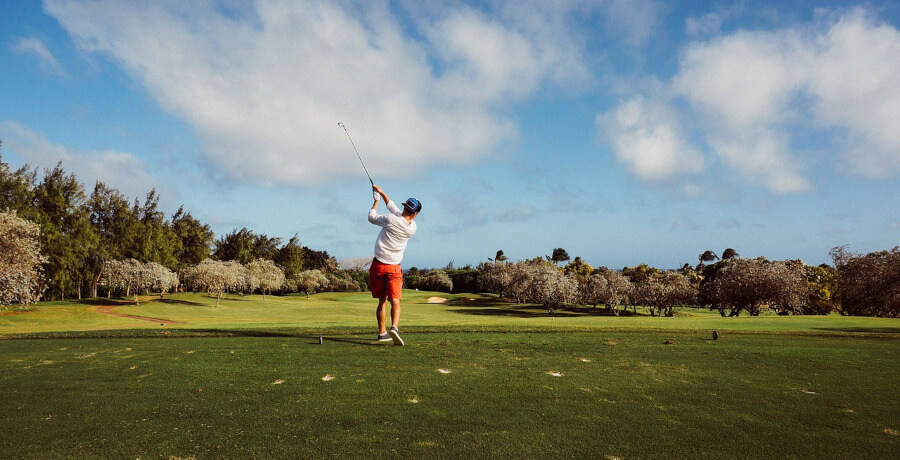 man playing golf on golf course at cloudy day