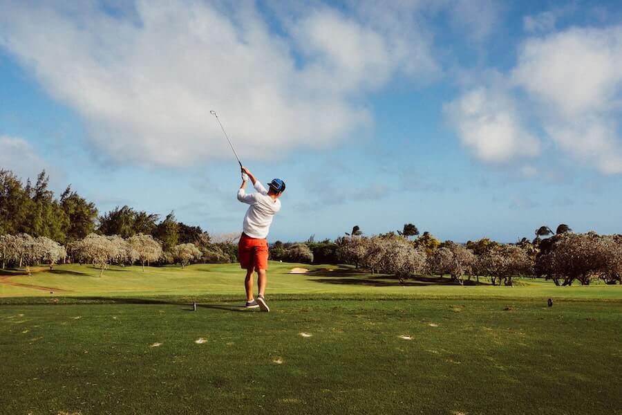 man playing golf - photo after golf swing