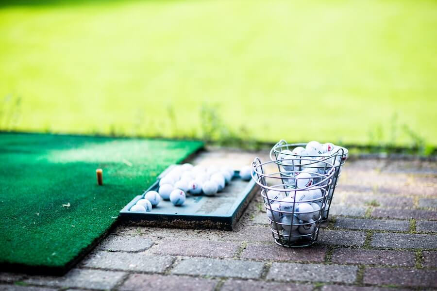 photo of golf balls on golf driving range